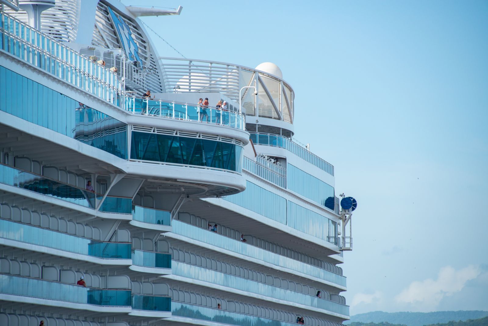 Tiers of private balconies on the side of a cruise ship, the heart of the balcony vs inside cabin choice